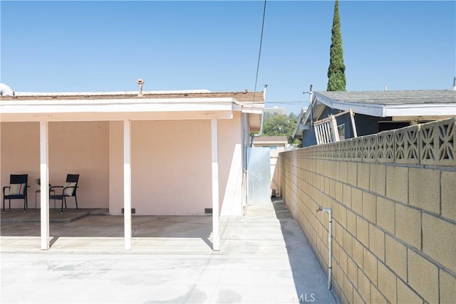 view of property exterior with a patio area