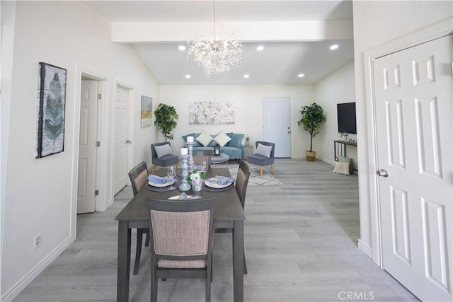 dining area with vaulted ceiling with beams, light wood-type flooring, and a notable chandelier