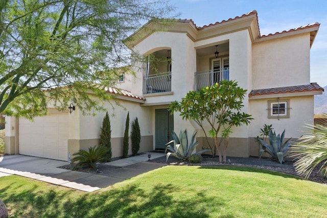 mediterranean / spanish-style house with a balcony, a front lawn, and a garage