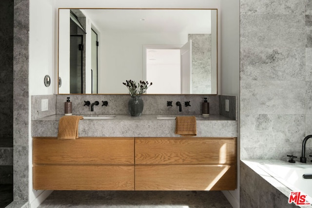 bathroom with a relaxing tiled tub and vanity