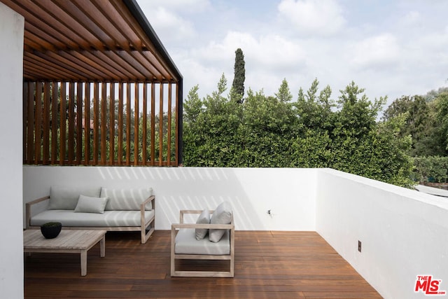 wooden terrace featuring an outdoor living space