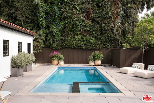 view of pool featuring an in ground hot tub and a patio