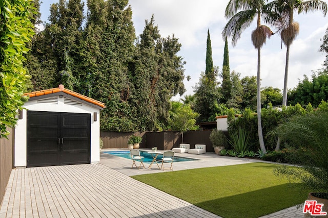 view of swimming pool featuring a lawn and a patio area