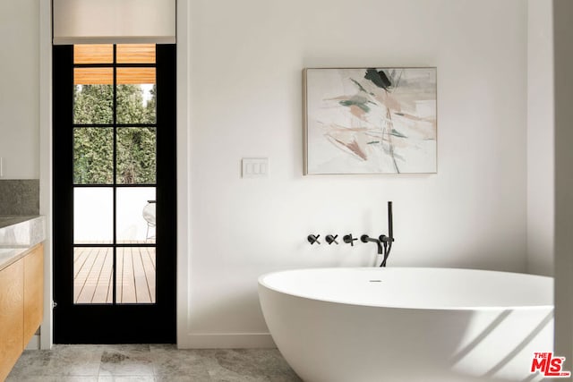 bathroom featuring a bathing tub and tile patterned flooring