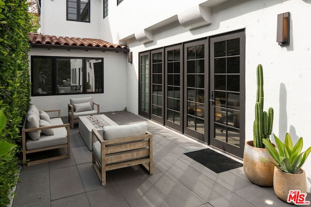 view of patio with french doors and an outdoor fire pit