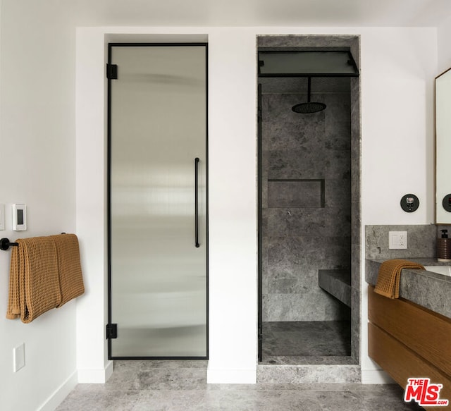 bathroom featuring a shower and vanity