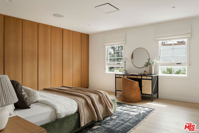 bedroom featuring light hardwood / wood-style floors and multiple windows