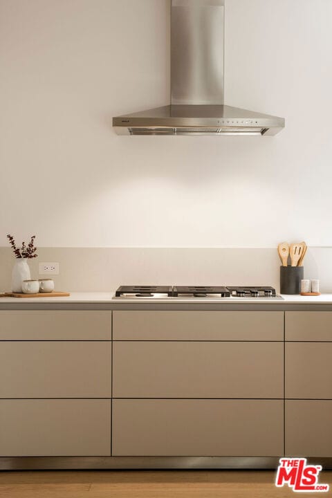 interior space featuring gas cooktop and wall chimney exhaust hood