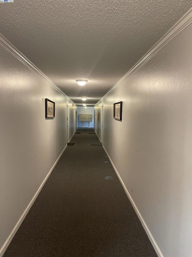 corridor featuring a textured ceiling and ornamental molding