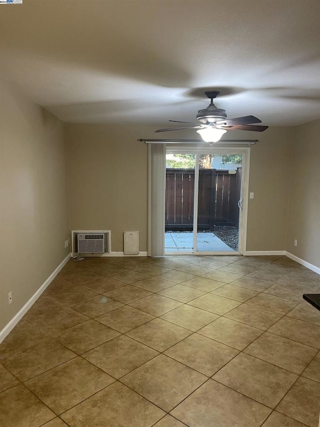 spare room with ceiling fan, a wall mounted AC, and light tile patterned flooring