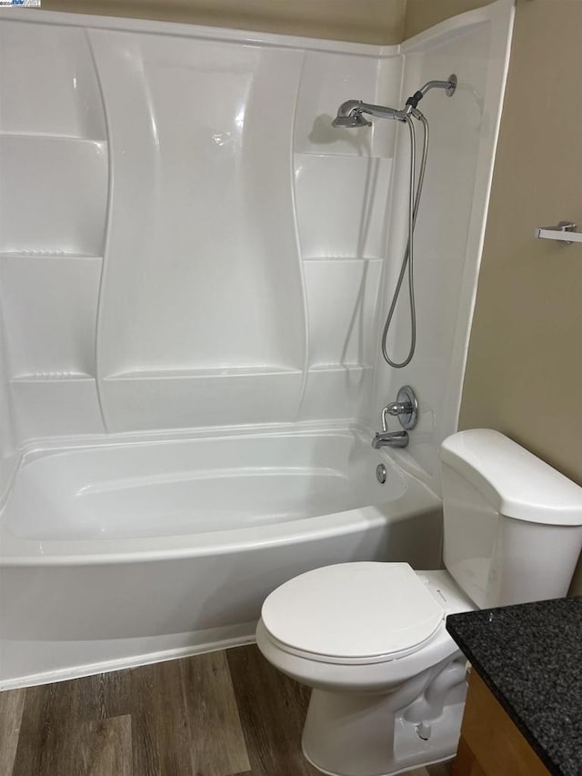 full bathroom featuring toilet, hardwood / wood-style floors, vanity, and bathtub / shower combination