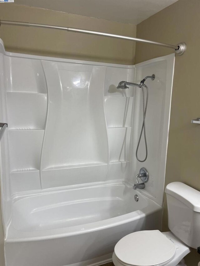 bathroom with toilet and shower / washtub combination