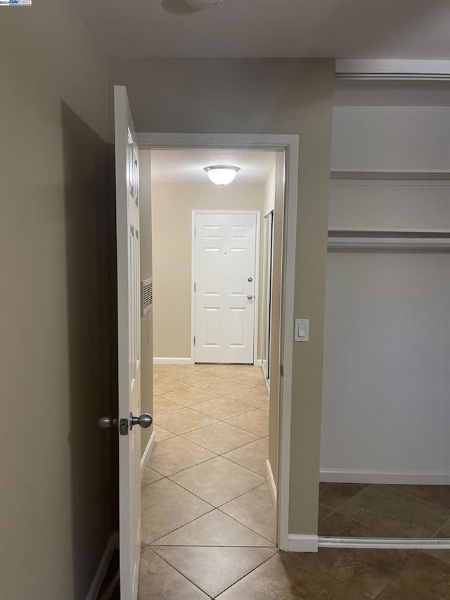 hallway featuring light tile patterned flooring