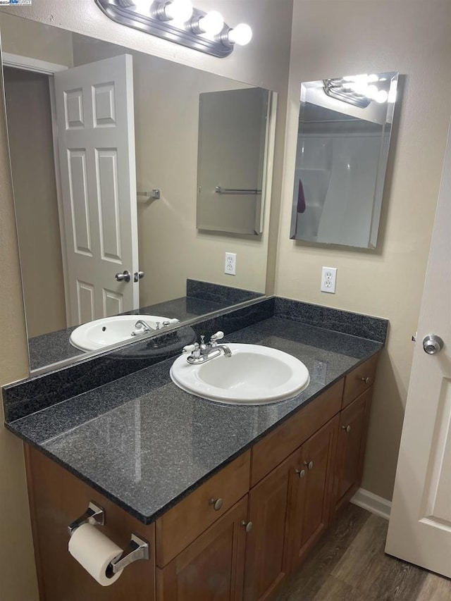 bathroom featuring hardwood / wood-style flooring and vanity