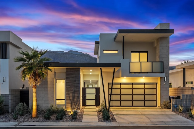 contemporary home featuring a garage and a mountain view