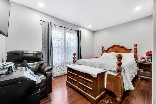 bedroom with dark hardwood / wood-style floors