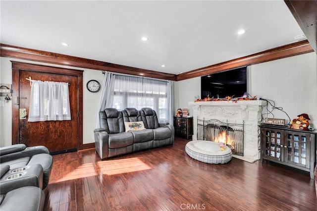 living room featuring dark wood-type flooring and ornamental molding