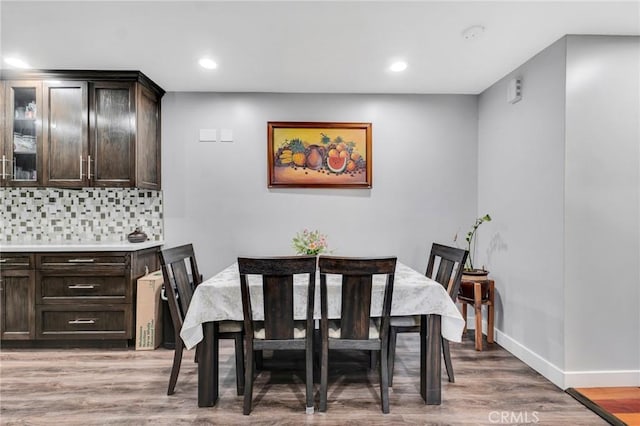 dining space with hardwood / wood-style floors