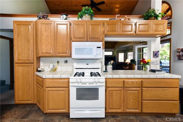 27547 W Shore Rd, Lake Arrowhead, CA 92352 - kitchen featuring white appliances, dark stone finish floors, tile counters, wooden ceiling, and lofted ceiling