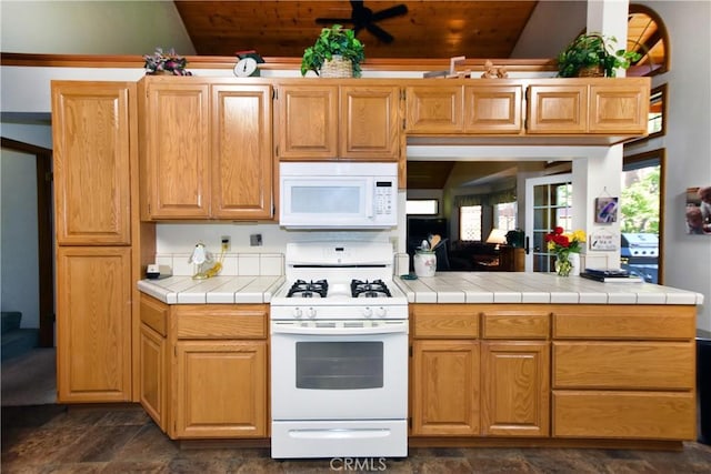 27547 W Shore Rd, Lake Arrowhead, CA 92352 - kitchen featuring white appliances, vaulted ceiling, dark stone finish flooring, wood ceiling, and tile counters
