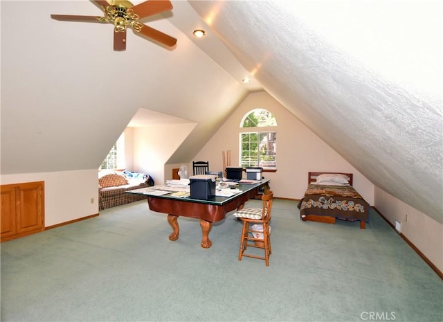 carpeted home office with vaulted ceiling, ceiling fan, and a textured ceiling