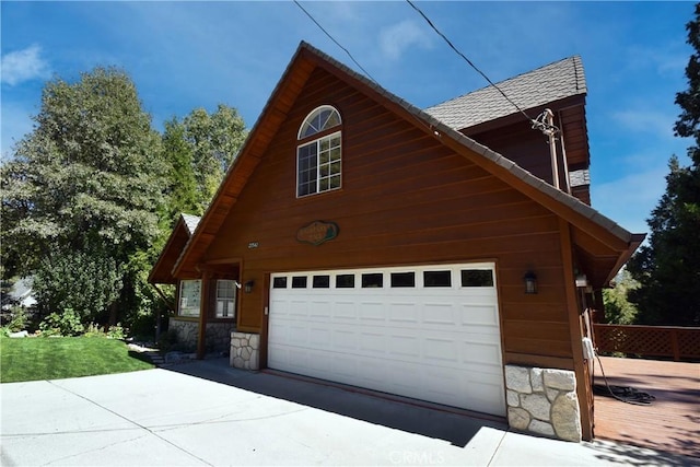 view of home's exterior featuring a garage, driveway, and stone siding