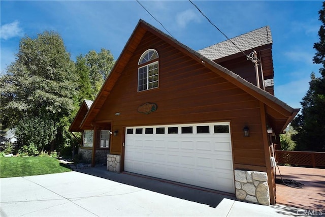 27547 W Shore Rd, Lake Arrowhead, CA 92352 - view of side of home with a garage, stone siding, and driveway