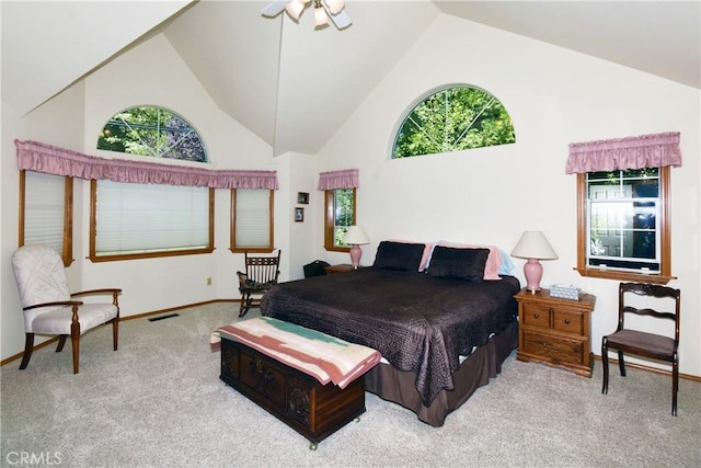 carpeted bedroom with high vaulted ceiling, multiple windows, and baseboards