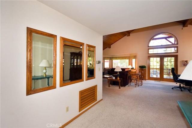 carpeted home office with high vaulted ceiling, beam ceiling, and visible vents