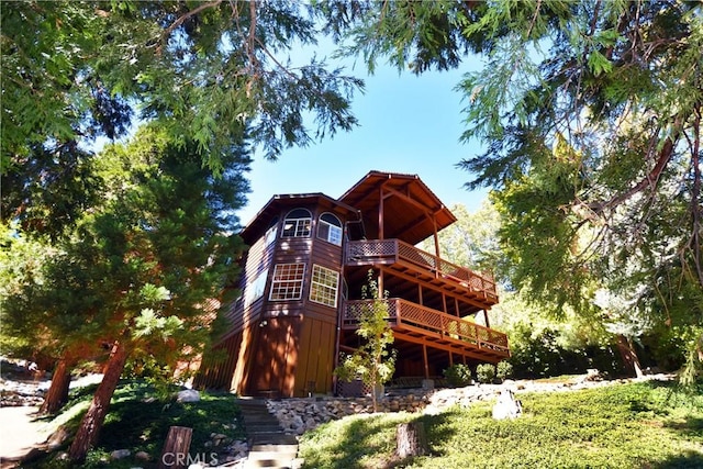 exterior space with stairway and a deck
