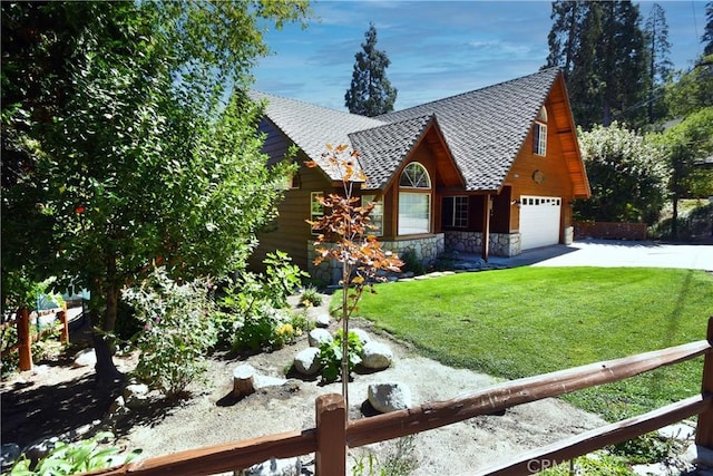 view of front of home featuring a shingled roof, an attached garage, a front lawn, stone siding, and driveway