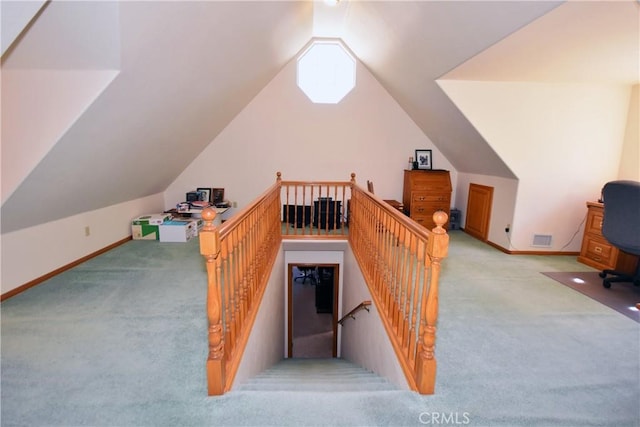 interior space featuring baseboards, visible vents, carpet flooring, and lofted ceiling