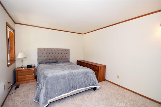 carpeted bedroom with baseboards and ornamental molding