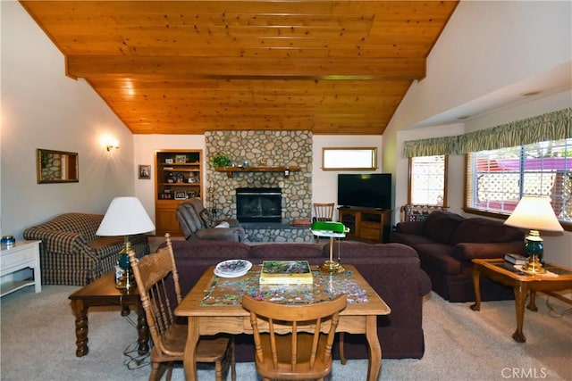 dining space with a fireplace, wood ceiling, vaulted ceiling, and light colored carpet