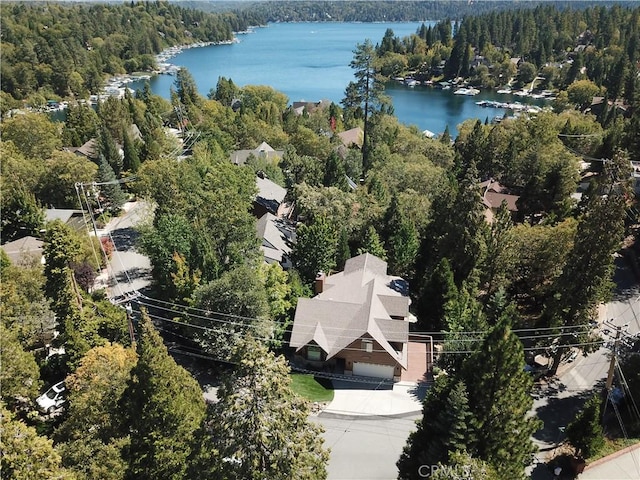 drone / aerial view featuring a water view and a view of trees