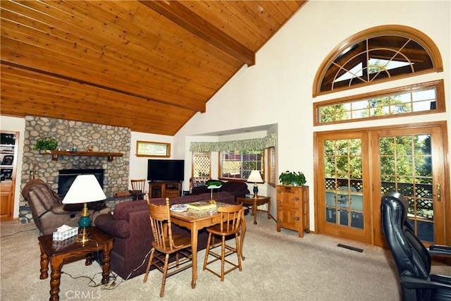 living room with light carpet, high vaulted ceiling, a stone fireplace, and wood ceiling