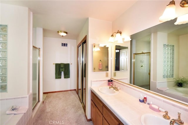 bathroom with vanity and independent shower and bath