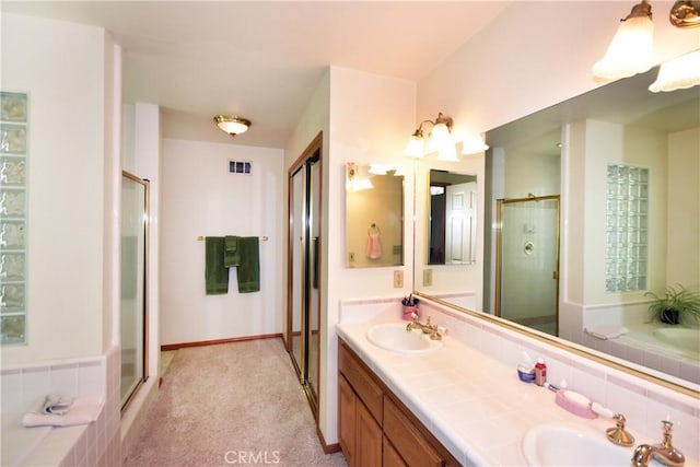 full bathroom with a sink, a shower stall, a bath, and visible vents