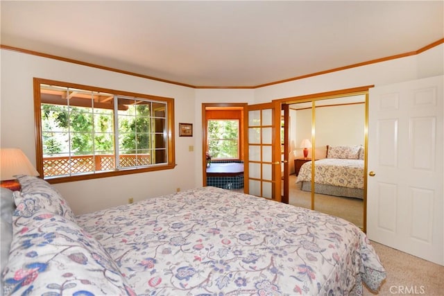 bedroom with crown molding, light carpet, french doors, and a closet