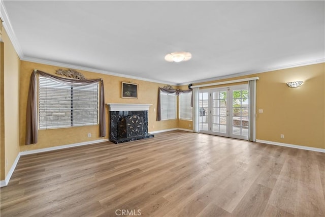 unfurnished living room with crown molding, a fireplace, and light hardwood / wood-style floors