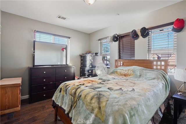 bedroom with dark hardwood / wood-style floors