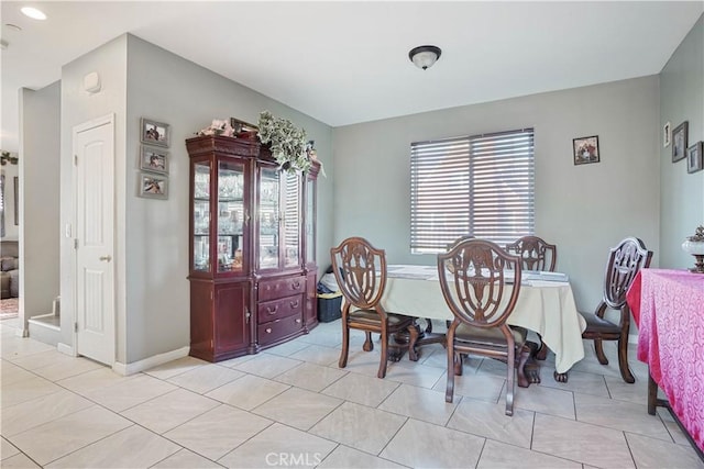 dining area with light tile patterned floors and a healthy amount of sunlight