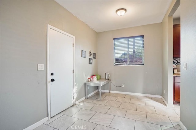 laundry room with light tile patterned flooring