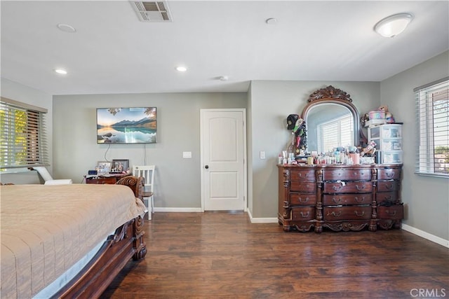 bedroom with dark hardwood / wood-style flooring and multiple windows