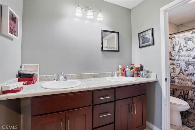 bathroom with toilet and vanity