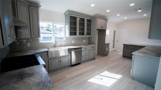 kitchen with gray cabinets, sink, stainless steel dishwasher, and light hardwood / wood-style floors