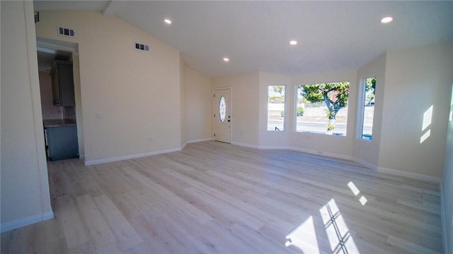 foyer entrance featuring lofted ceiling with beams and light hardwood / wood-style floors