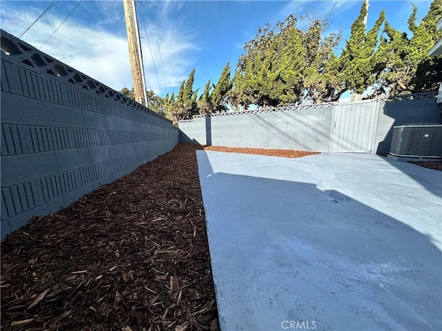 view of yard with a patio and central AC