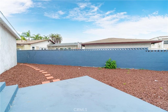 view of yard featuring a fenced backyard and a patio