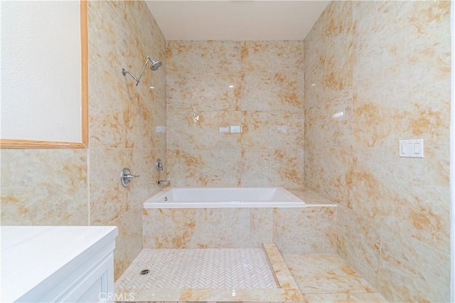 full bathroom featuring tiled shower / bath combo and tile walls